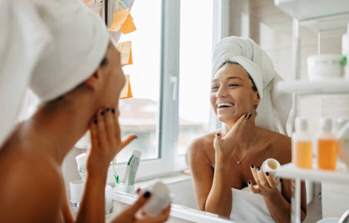 smiling woman looking in mirror